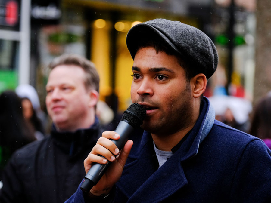 danyl johnson speaking into microphone outdoors