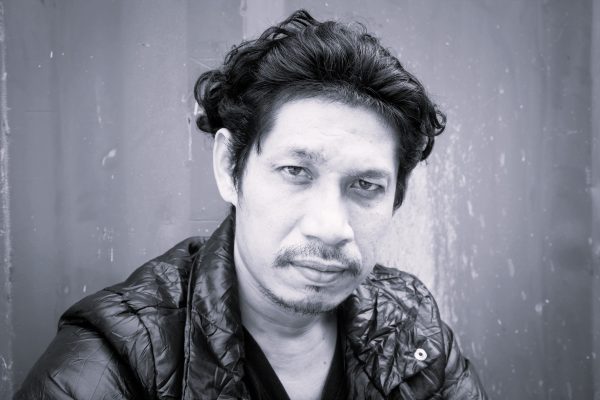 Man with black hair sitting