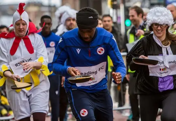 Reading FC team member running in the Pancake Race