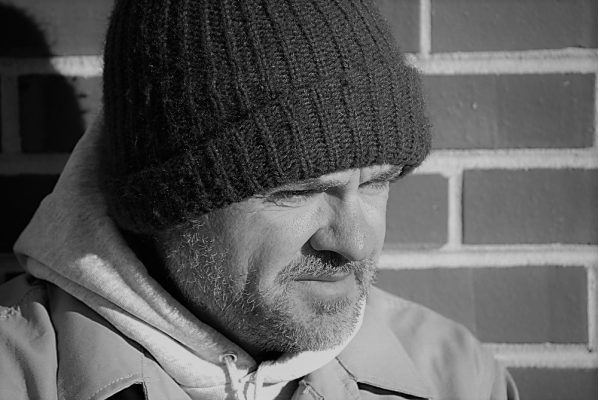 Head shot of man wearing a beanie hat