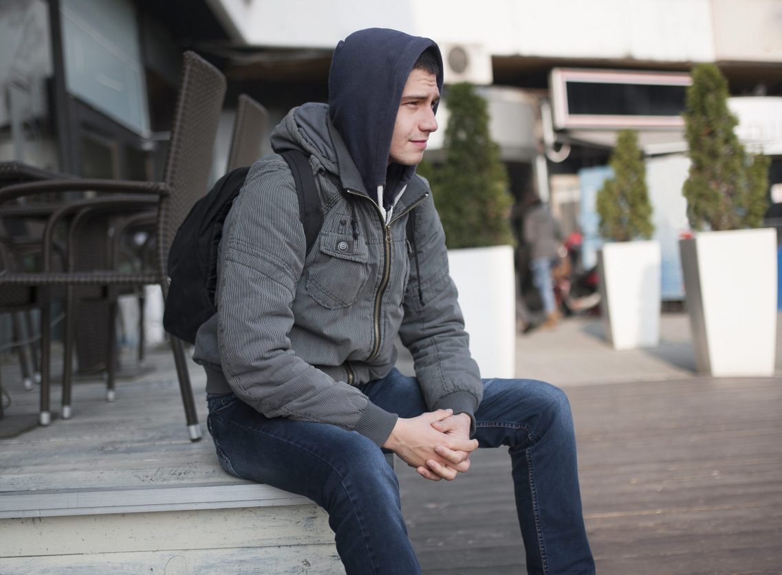 Man sitting in the street, illustrating Launchpad's Supported Housing service