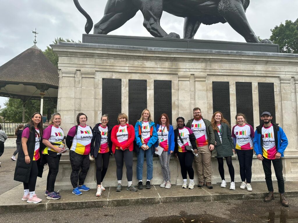 A dozen walkers standing in front of the lion in Forbury Gardens before starting the Reading Legal Walk