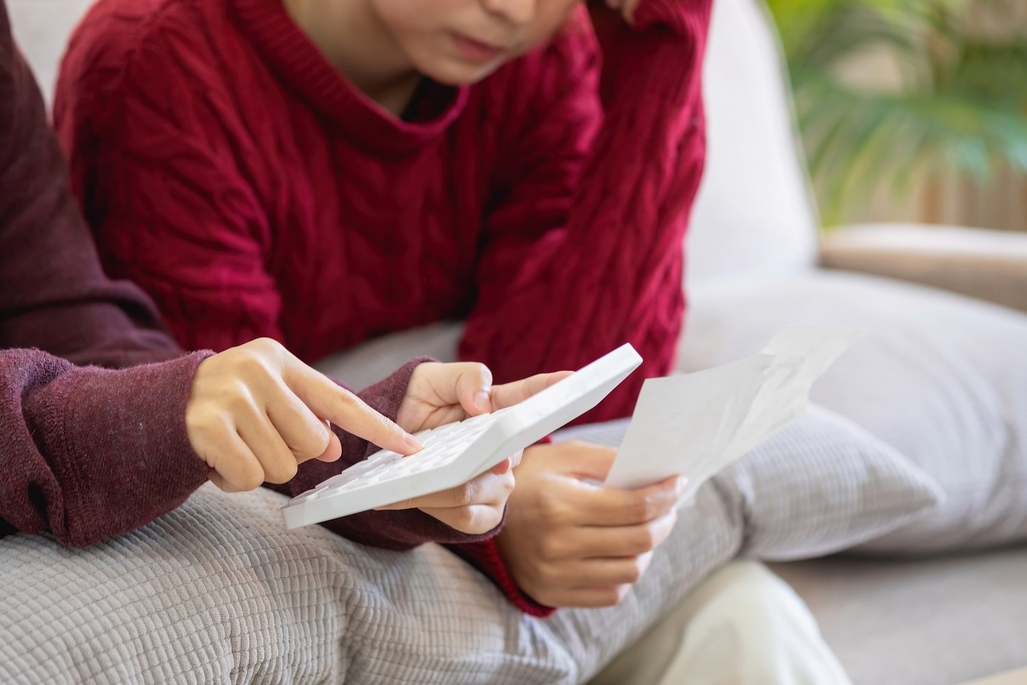 A woman looking at a calculator