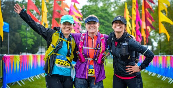Photo of three runners , smiling at the camera at the Goring Gap Run event