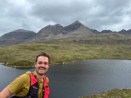 Man looking at the camera with hills in the background