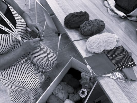 woman knitting with yarns of wool