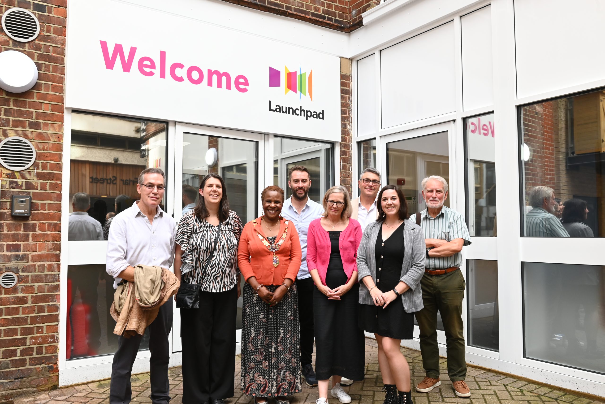 group of people outside Launchpad's new front door