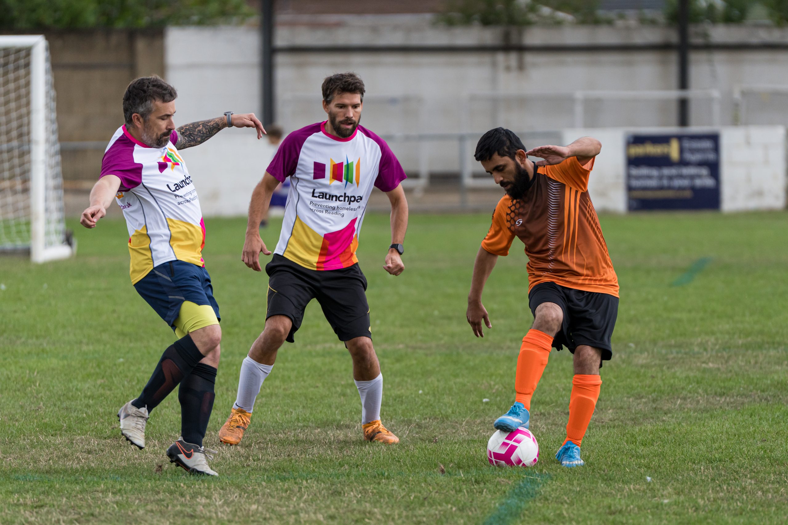 footballers in action kicking a ball