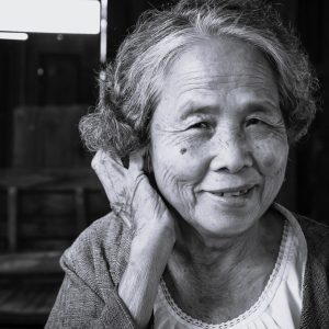 Older Chinese woman looking at the camera