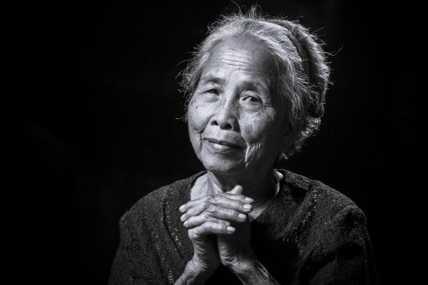 Older Chinese woman looking directly at the camera.