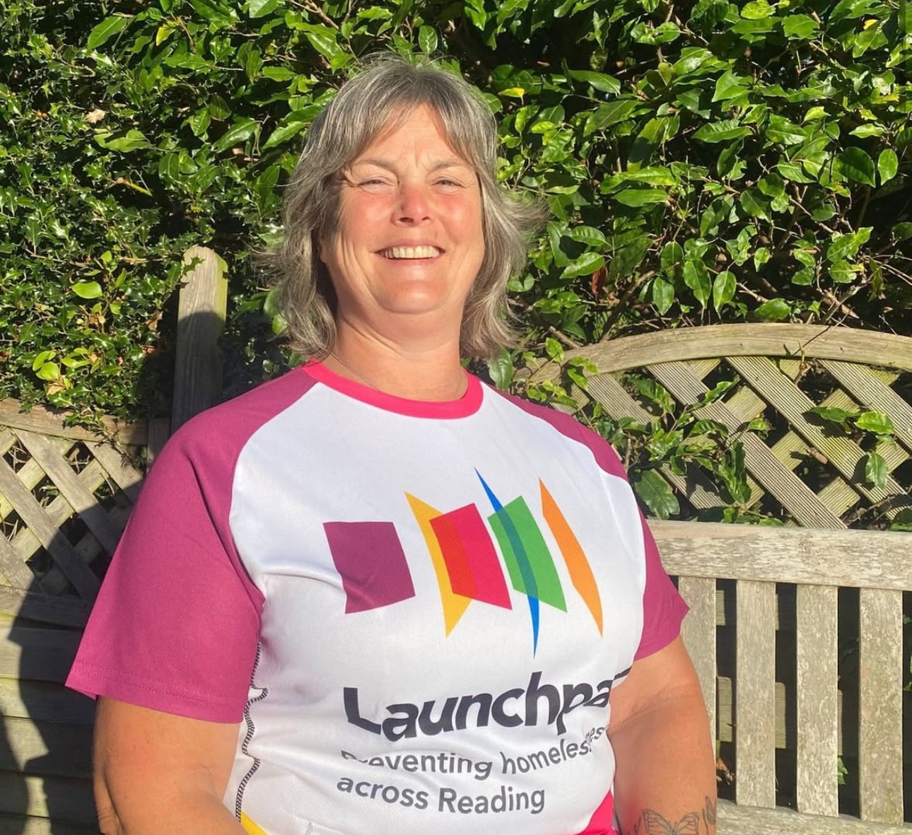 woman smiling wearing a Launchpad banded top