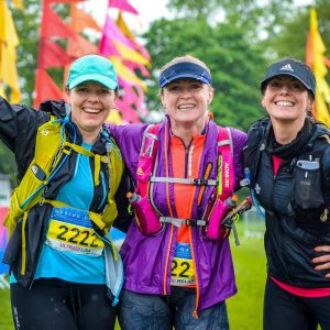 Three ladies talking part in the Goring Gap, smiling at the camera