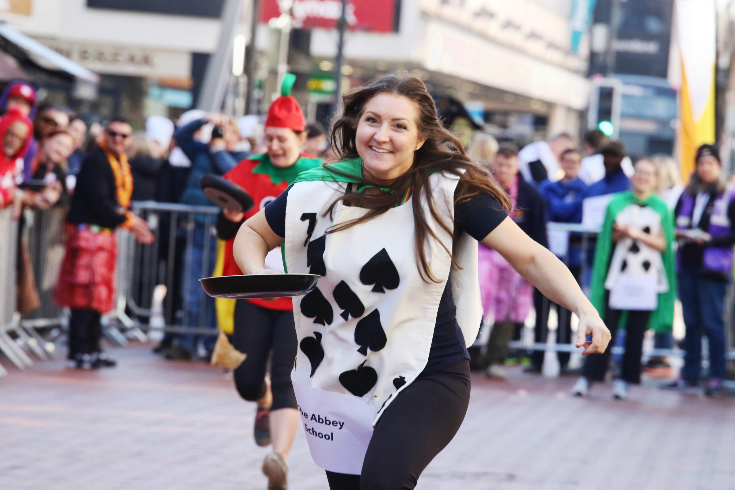 Woman dressed as a playing card running in Pancake Day Race