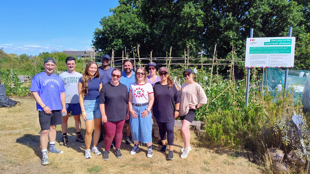 a group of people standing on our allotment