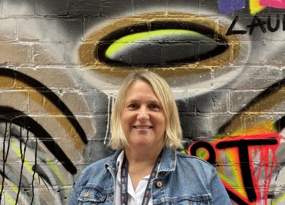 Alyson stanging in front of mural