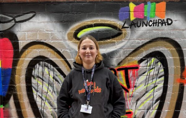 Peggy standing in front of our mural