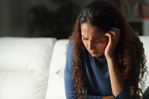 anxious woman on a sofa